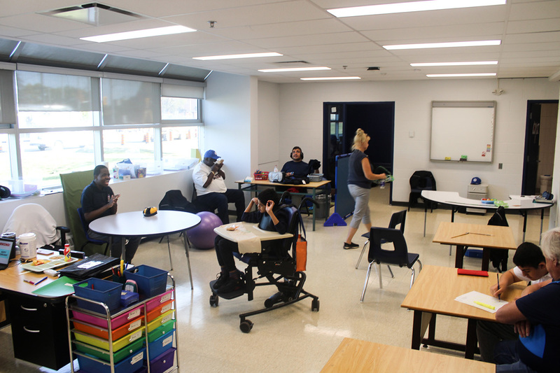 Photo of Father Henry Carr ISP students and staff in a newly renovated classroom