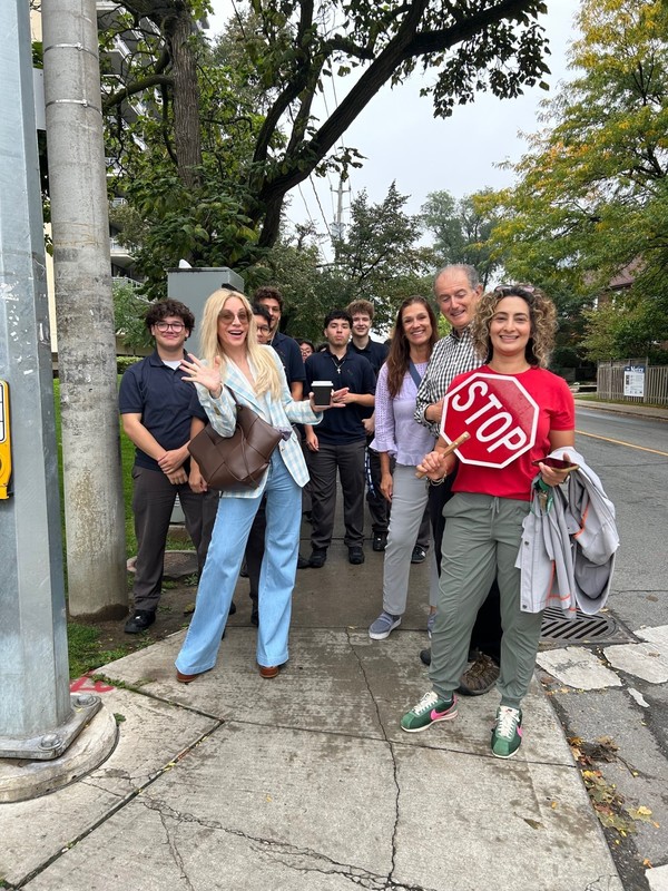 A group of students and staff posing outdoors.