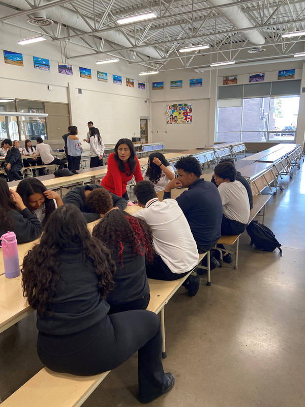 Photo of JCM staff and new English Language Learner students conversing together at the Meet-and-Greet
