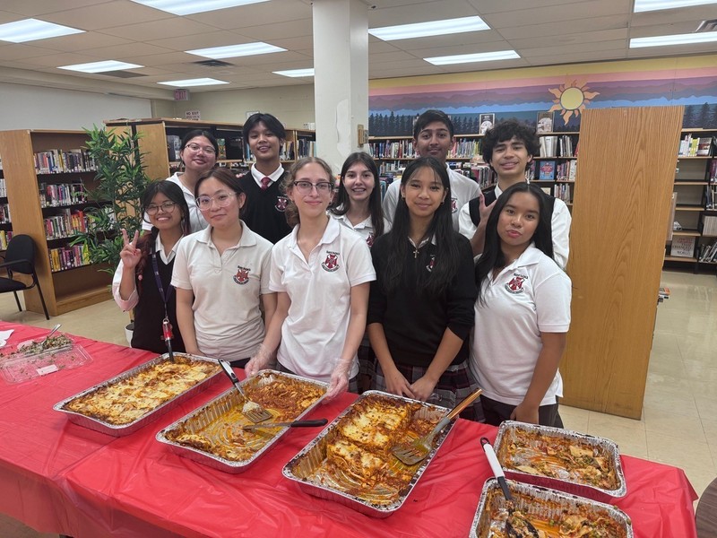 Photo of St. Patrick students in front of the food the served to the teachers at the celebration