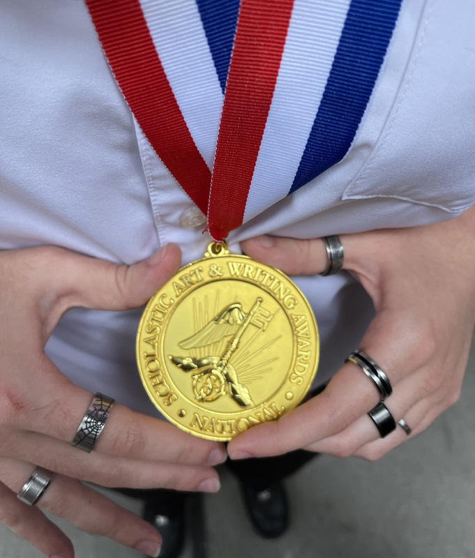 Closeup photo of Diana's hands holding her gold medal