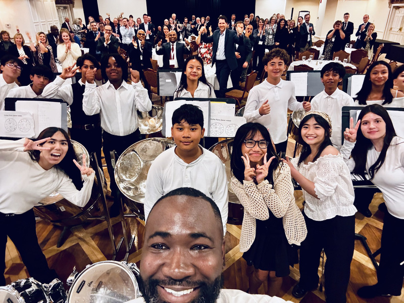Group photo of Holy Spirit Catholic School's Steel Orchestra students along with their teachers and gala attendees