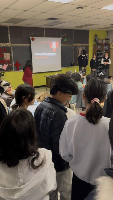 Attendees view Advanced Placement presentation  at St. Patrick CSS Open House 2025