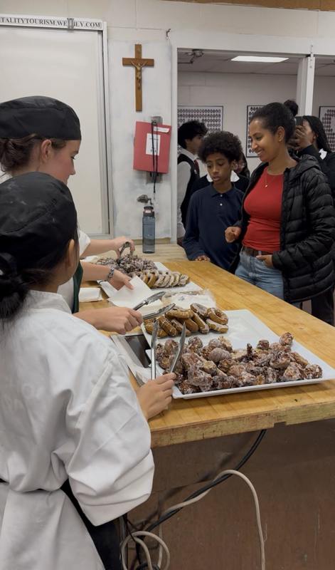 Attendees take food at St. Patrick CSS Open House 2025