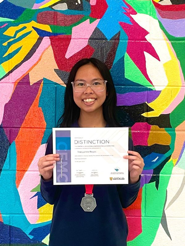 student holding a certificate