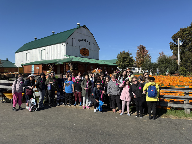 Group photo of Loretto College School students and staff in front of Downey's Farm next to the pumpkin patch