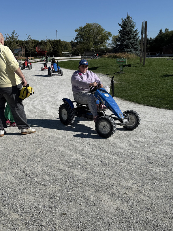 Photo of students trying out driving toy trucks