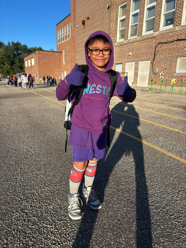 Photo of St. Margaret student dressed in purple for Dress Purple Day
