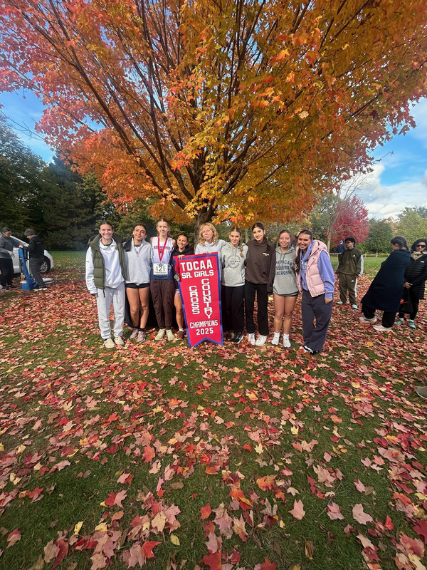 Group photo of the Father John Redmond cross country team with their TDCAA Senior Girls Championship banner