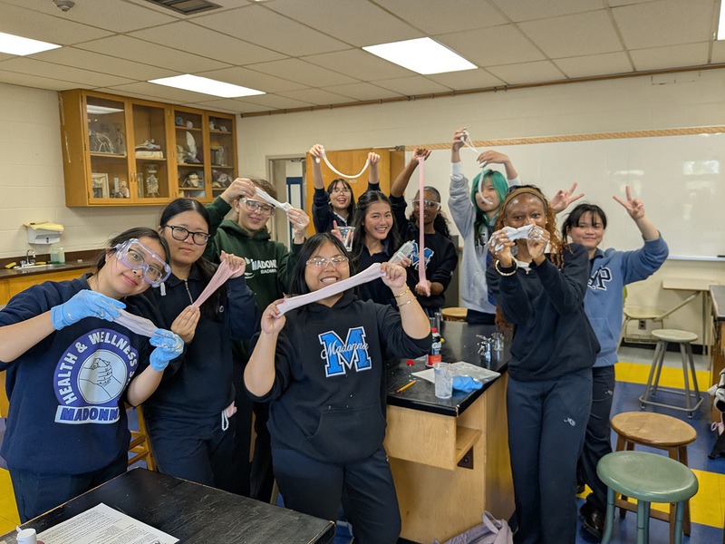 Group photo of Madonna students showing off the silly putty they made
