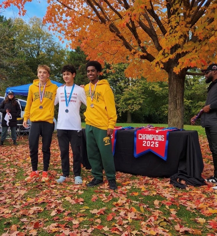 Photo of two Chaminades students and a Neil McNeil student posing with their medals