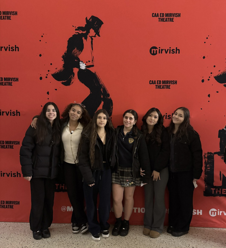 Group photo of Loretto College School students and staff in front of a poster for MJ the Musical