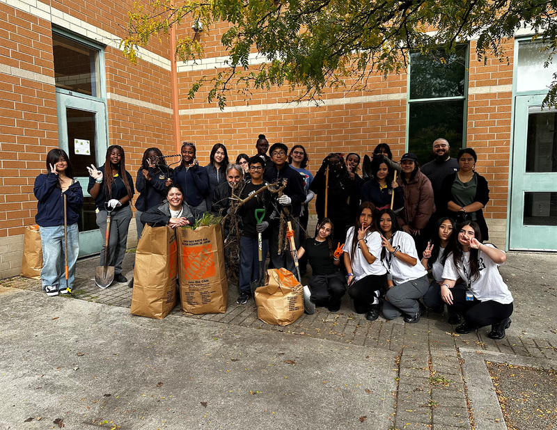 Group photo of the students and staff of the Nature Club from St. Basil-the-Great College school, posing in the courtyard they cleaned up with their tools