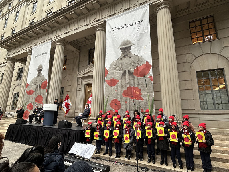 Photo of Our Lady of Lourdes students performing in front of TCDSB staff and Manulife personnel