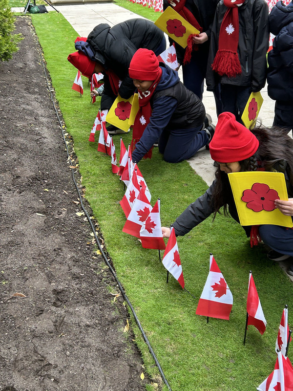 Photo of Our Lady of Lourdes students planting Canada flags