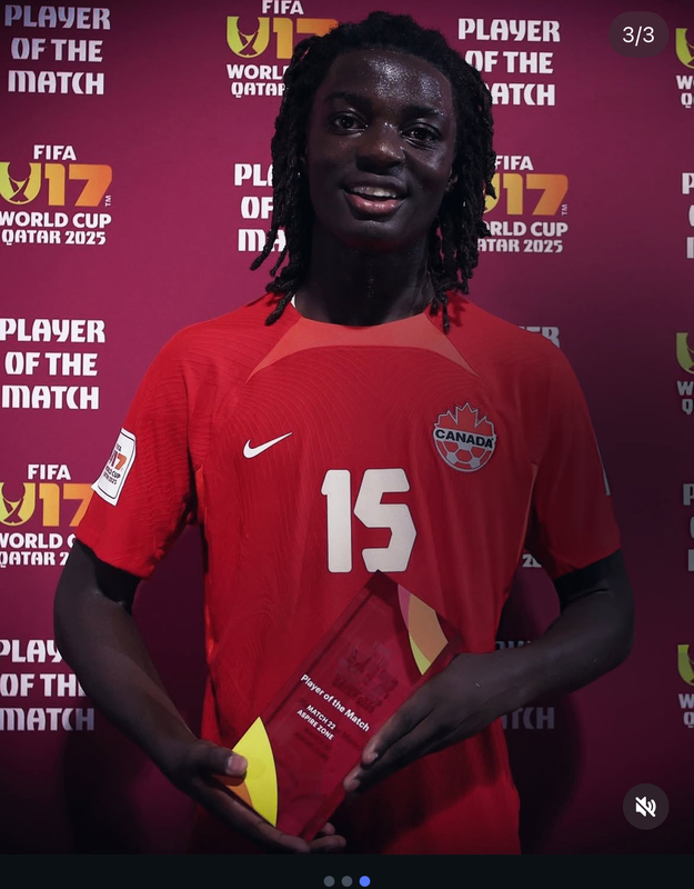 Photo of Elijah in his jersey with his award