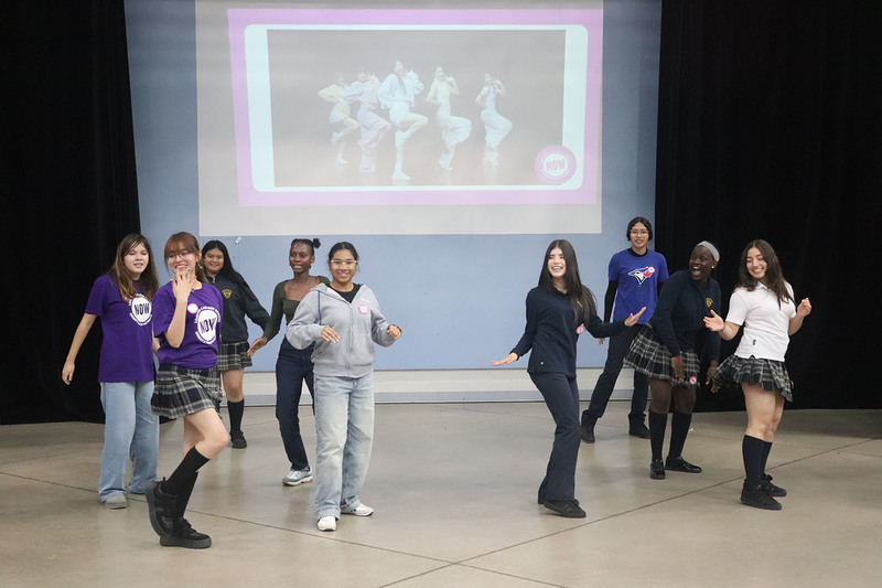 Photo of Loretto College students dancing together, both peer leaders and newcomer students, during the event