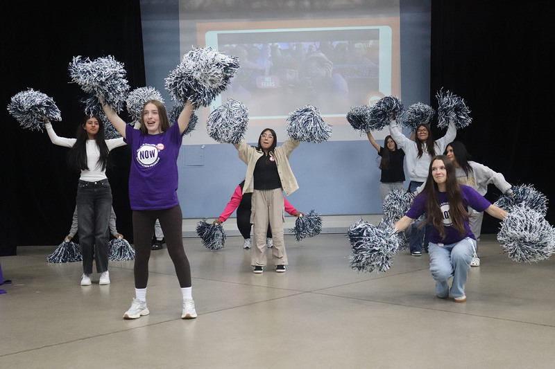 Photo of Loretto College students dancing together, both peer leaders and newcomer students, during the event