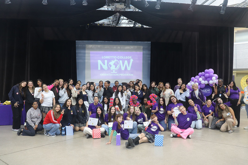 Photo of Loretto College students dancing together, both peer leaders and newcomer students, during the event