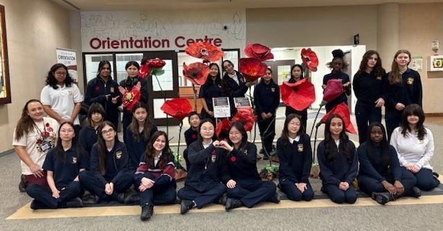 Group photo of Cardinal Carter students posing with their poppy installation