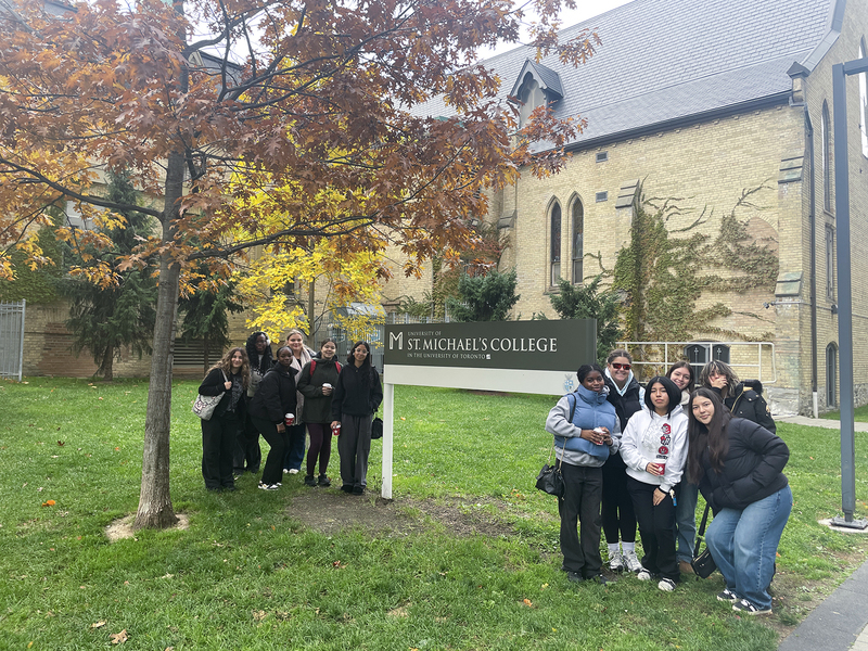 Group photo of Loretto College School students in front of the St. Michael's College sign