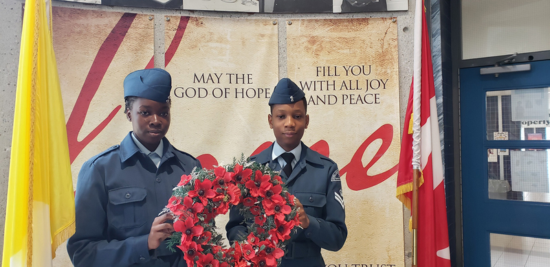 Photo of two St. Oscar Romero students who are Air Cadets with the Remembrance Day wreath
