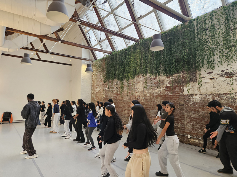 Photo of SJOA students dancing with Trevino Williams at the Hip Hop Workshop