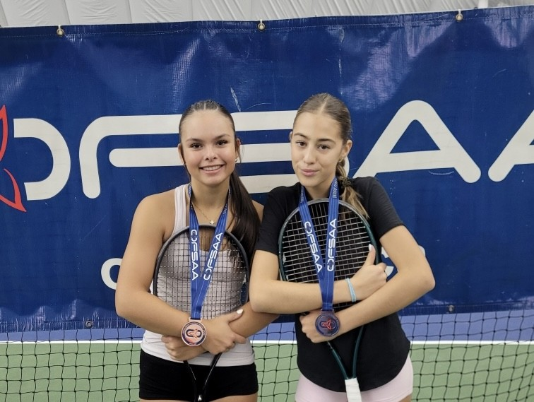 two girls posing with tennis racquets and OFSAA medals