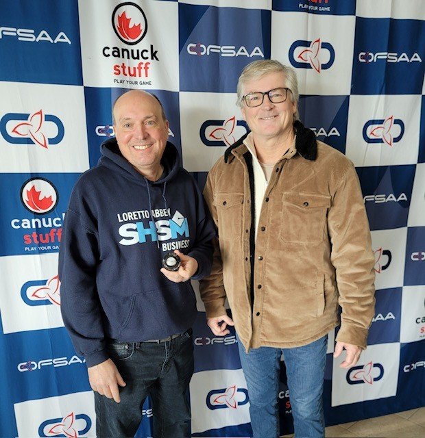 two men posing in front of OFSAA banner