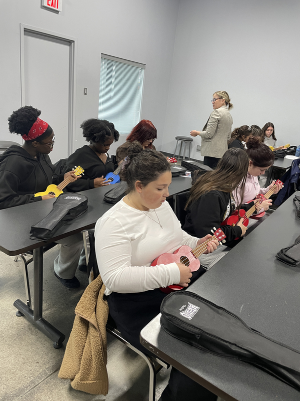 Photo of Loretto College students playing ukulele at the Music Care Conference