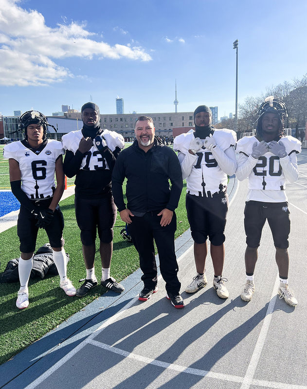 Group photo of JCM student athletes with their coach
