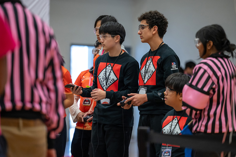 Photo of 24418 Canoe team working on their robotics project for the tournament