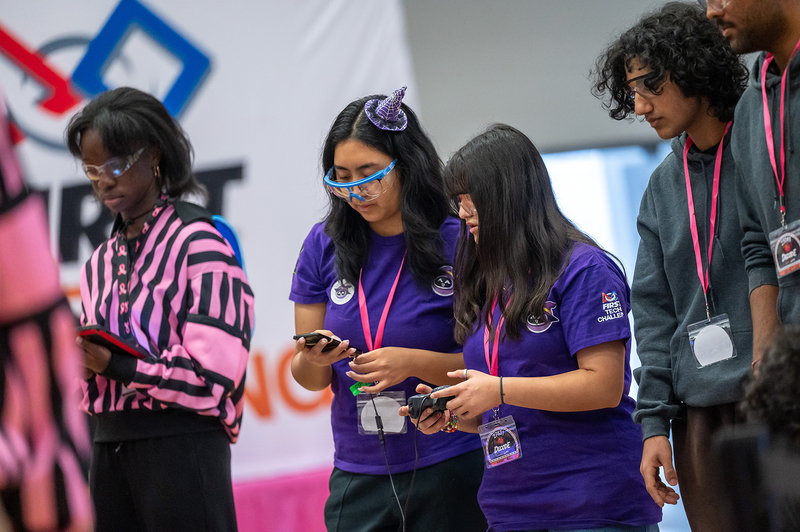 Photo of 27631 Bewitched team working on their robotics project for the tournament