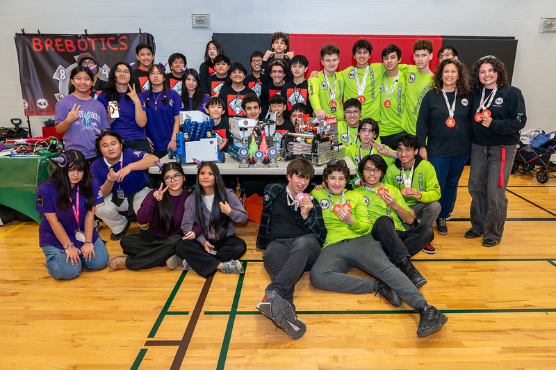 Group photo of 24418 Canoe, 18846 Brebotics, and 27631 Bewitched teams together with their medals and projects