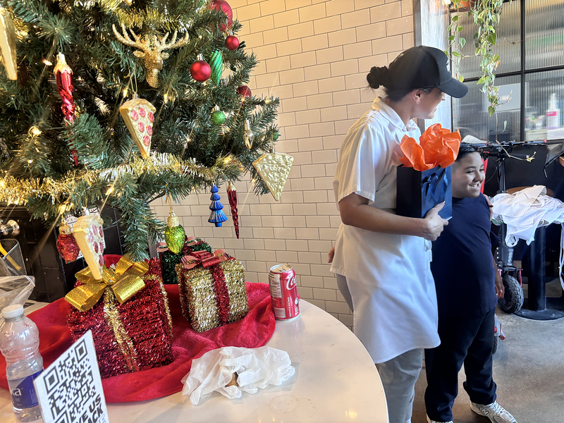 Photo of Santa Maria students and staff making pizza with North of Brooklyn Pizzeria staff