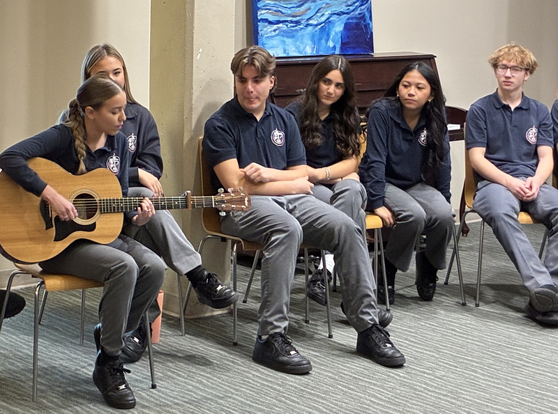 Photo of Father John Redmond students listening and playing music during the session