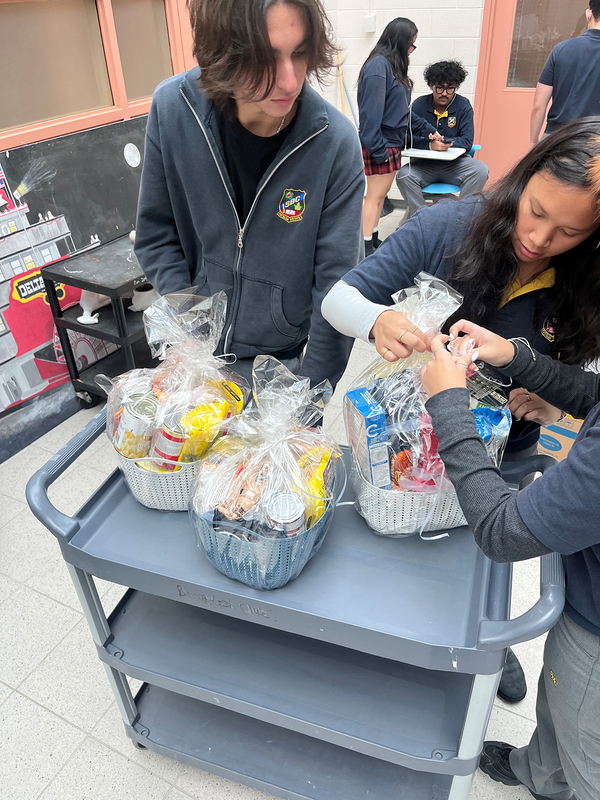 Photo of St. Basil-the-Great College School's leadership students organizing the food that they collected for the drive
