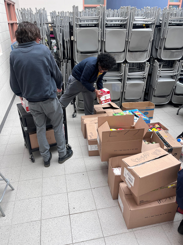 Photo of St. Basil-the-Great College School's leadership students organizing the food that they collected for the drive