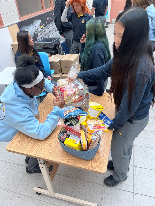 Photo of St. Basil-the-Great College School's leadership students organizing the food that they collected for the drive