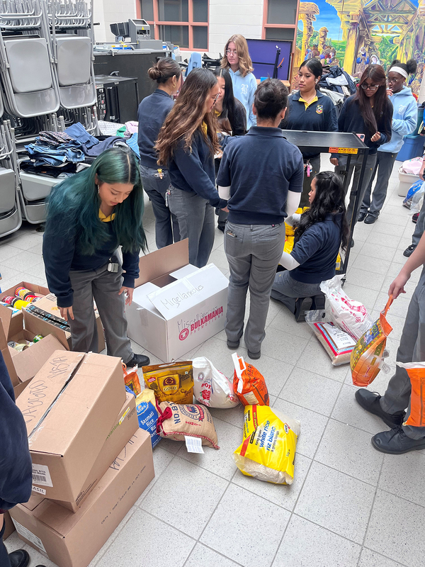 Photo of St. Basil-the-Great College School's leadership students organizing the food that they collected for the drive