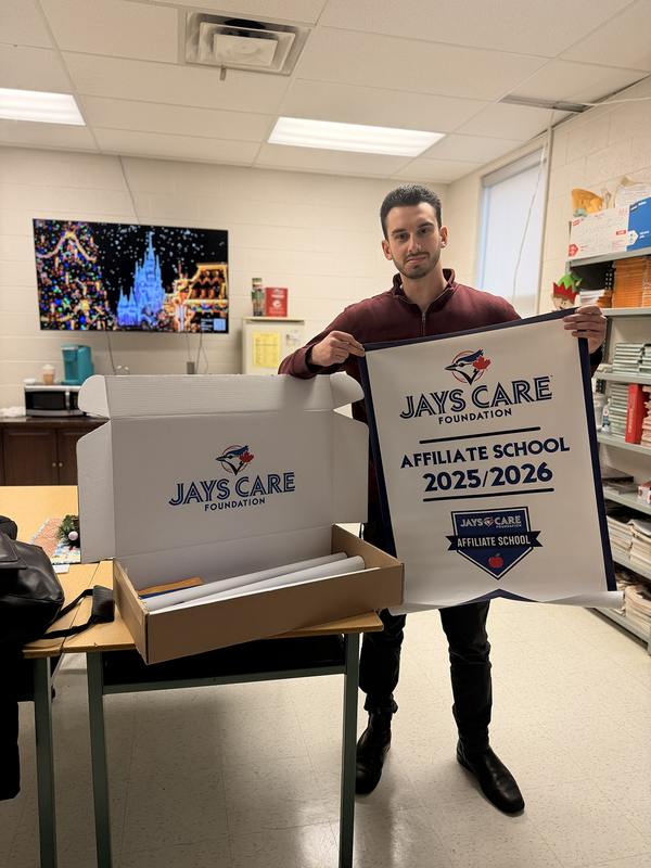 Photo of JCM staff member holding a banner announcing the affiliation