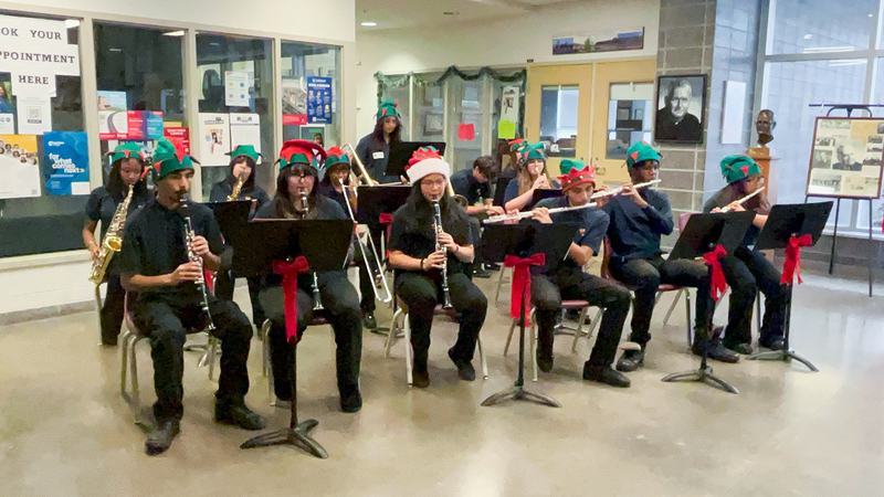 Photo of Monsignor Percy Johnson music students performing with wind instruments at the market