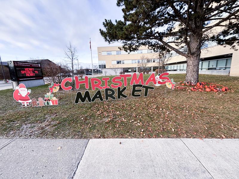 Photo of the Christmas Market sign on the school grounds in front of the school building