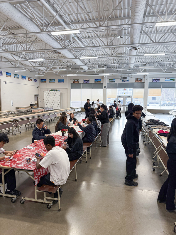 Photo of James Cardinal McGuigan's newcomer students enjoying snacks and warm drinks