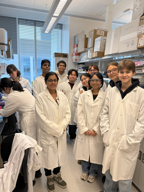 Photo of St. Patrick students in lab coats at the SickKids Hospital Peter Gilgan Centre for Research and Learning