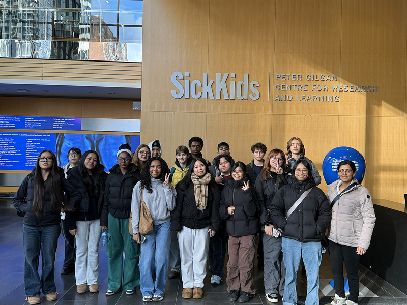 Group photo of St. Patrick students and staff in front of the SickKids Hospital Peter Gilgan Centre for Research and Learning