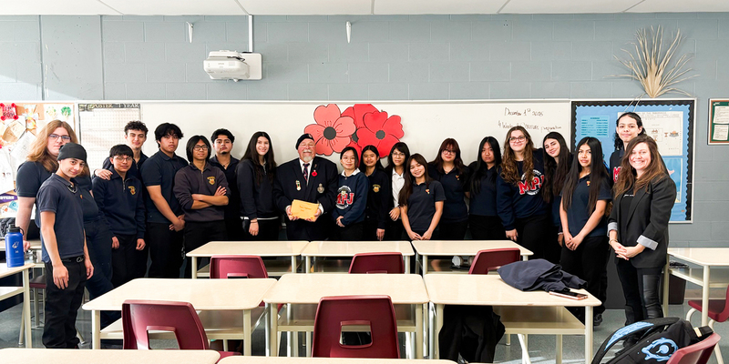 Group photo of MPJ students and staff with Corporal Hlywka upon presenting the donation