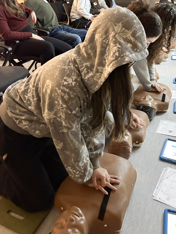Photo of students practising CPR on dummies