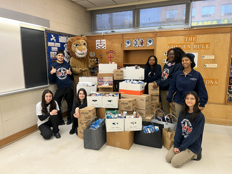 Photo of BMTM students with the boxes of donations that they collected