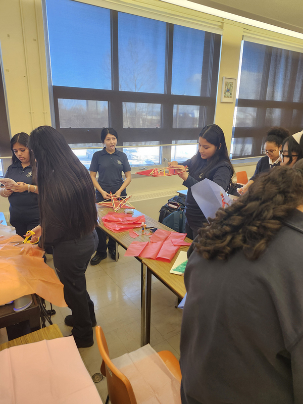 Photo of students building their parols